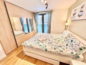 a bedroom with a bed and a large mirror at The Works - Two bed penthouse in Manchester