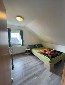 a small bedroom with a bed in a room at Dach Zimmer D1 in Falkenberg
