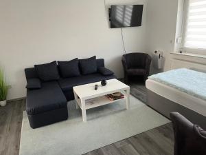 a living room with a couch and a bed at Ferienwohnung am Grambker See in Bremen
