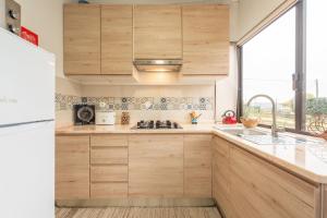 una cocina con armarios de madera y fregadero en Countryside paradise in Bucelas, en Bucelas