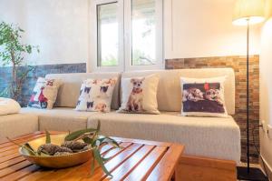 a living room with a couch with pillows and a table at Countryside paradise in Bucelas in Bucelas