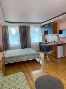 a large room with a bed and a kitchen at Rest in Palanga in Palanga