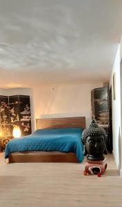 a bedroom with a large bed with a black mask on it at Cosy Appart in Marseille
