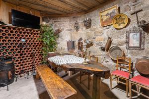 a dining room with a table and a wall of wine barrels at Retro-modern retreat in Esposende in Esposende