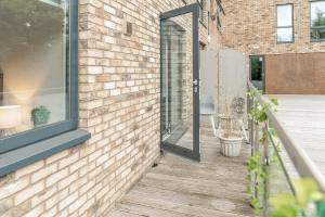 a brick house with a glass door on a porch at Fabulous Birmingham City Centre 2 Bedroom Apartment - Private Terrace - Top Rated - 004H in Birmingham