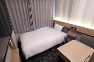 Postel nebo postele na pokoji v ubytování Washington R&B Hotel Otsuka Eki Kitaguchi