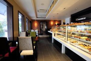 a restaurant with a display case filled with pastries at Arunreas Hotel in Phnom Penh
