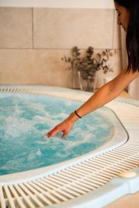 a woman is standing in a hot tub at Bellettini Hotel in Milano Marittima