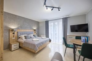 Łóżko lub łóżka w pokoju w obiekcie Avangard by Baltic Home