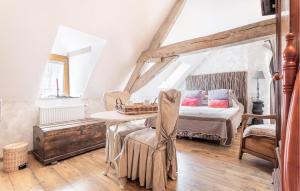 a bedroom with a bed and a table and chairs at Beautiful Home In Ferrire-la-petite With Wifi in Ferrière-la-Petite