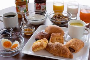 a table with a plate of pastries and cups of coffee at R&B Hotel Otsuka Eki Kitaguchi in Tokyo
