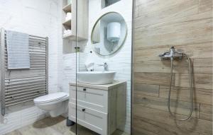 a bathroom with a sink and a toilet and a mirror at Gorgeous Apartment In Blace in Blace +18 photos