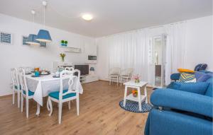 Una sala de estar con una mesa y un sofá azul. en 3 Bedroom Amazing Home In Malinska, en Županje