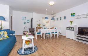 Una sala de estar con un sofá azul y una mesa. en 3 Bedroom Amazing Home In Malinska, en Županje