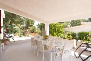 a white table and chairs on a patio at Casa Vacanze Maria in San Vito lo Capo