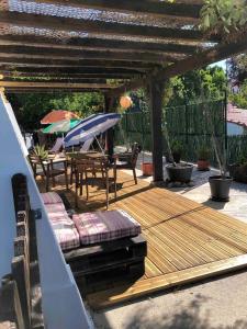 una terraza de madera con mesa y sombrilla en GuestReady - Nature's Haven Retreat en Pedrógão Pequeno