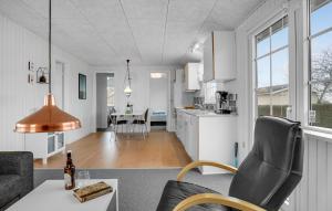 a white kitchen and living room with a table and chairs at Nice Home In Haderslev With Wifi in Haderslev