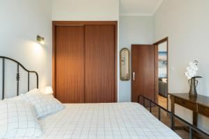 a bedroom with a bed and a wooden door at Casa Curva do Rio in Melres
