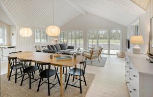 a kitchen and living room with a table and chairs at Beautiful Home In Aakirkeby With Kitchen in Vester Sømarken