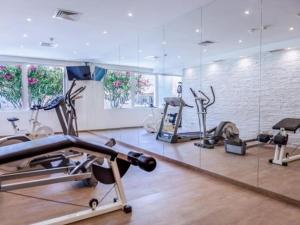 a gym with several treadmills and cardio machines at Albufeira Sol Villas III by Stay ici in Albufeira