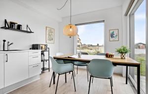 a kitchen with a dining room table and chairs at Kysthusene, Lejl 25 in Slagelse