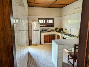 a kitchen with a refrigerator and a table in it at ROMO house in Cotonou
