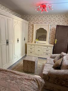 een woonkamer met een bank en een groot dressoir bij العين الهيلي مصباح ب 8 in Al Ain