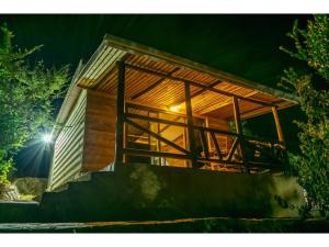 a house with a staircase leading up to it at night at Mua Hills Getaway in Katelembu