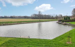 a river in a field with grass and trees at Amazing Home In Vlagtwedde With Wifi in Vlagtwedde