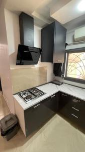 a small kitchen with a stove and a window at Appartement Haut Standing in Dakar