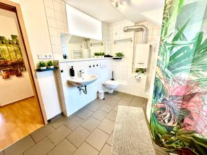 a bathroom with a sink and a toilet at Dschungel Wohnung, geräumig, Netflix, Sonos, zentral in Duisburg +18 photos