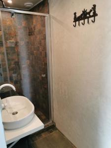 a bathroom with a sink and a shower at Rietumi in Kolka +8 photos