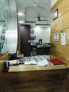 an office with a desk with books on it at Hare Krishna Main Bazar in New Delhi
