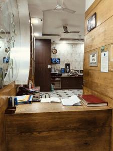 an office with a desk with books and papers on it at Hare Krishna Main Bazar in New Delhi