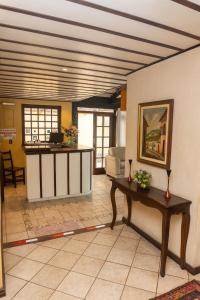 a living room with a counter and a table at Hotel Colonial in São Lourenço