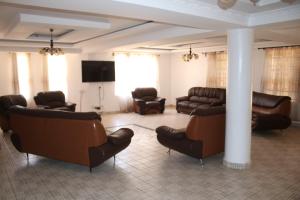a living room with couches and chairs and a television at Wagaview place villa in Nairobi