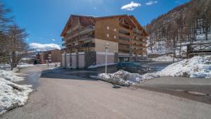 a building on the side of a snow covered road at C du Verdon 312- appt au pied des pistes 6-7 pers in Allos