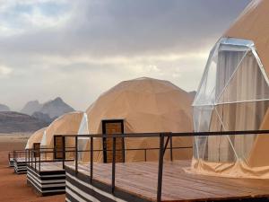 a row of domed tents in the desert at Shaheen Camp Wadi rum in Wadi Rum