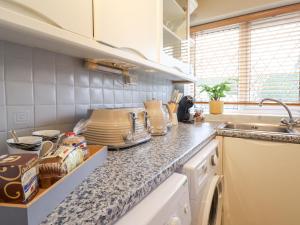 a kitchen with a counter top with dishes on it at The Crib in Llandudno