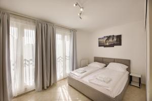 Łóżko lub łóżka w pokoju w obiekcie Promenada by Baltic Home