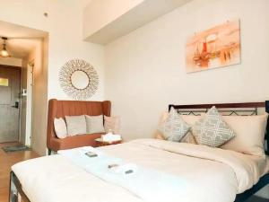 a bedroom with a large white bed and a mirror at The Loop Studio at 5th floor Limketkai Mall infront Atrium Lucky 11 in Cagayan de Oro