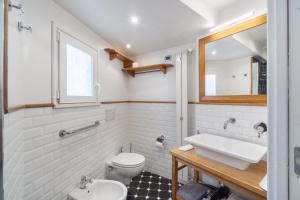 a bathroom with a sink and a toilet at La Casa nel Cortile in Vico Equense