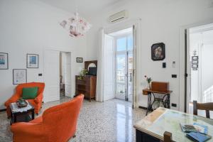 a living room with orange chairs and a table at La Casa nel Cortile in Vico Equense +66 photos