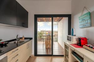 a kitchen with a door open to a patio at Villa Shepherd Lajares - LUXURY VILLA FUERTEVENTURA in Lajares