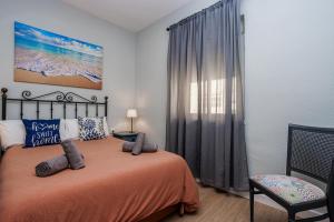 um quarto com uma cama e uma janela em Apartamento Playa Santa María del Mar em Cádiz