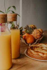 a table with a plate of fruit and orange juice at Villa Shepherd Lajares - LUXURY VILLA FUERTEVENTURA in Lajares