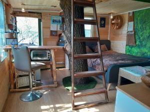 a room with a bunk bed and a desk in a tiny house at Tree House Ramona in Grosuplje