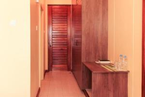 a hallway with a wooden door and a wooden desk at LIA Hotel & Training Centre in Nairobi