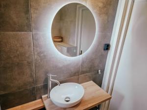 a bathroom with a sink and a mirror on the wall at De Gelukskever renovated 2024 in Hindeloopen