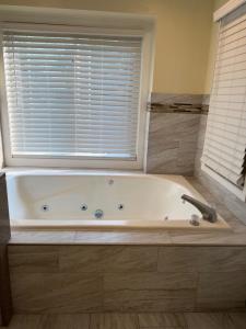 a bath tub in a bathroom with a window at Dells Paradise At Lighthouse Cove Condominiums in Wisconsin Dells